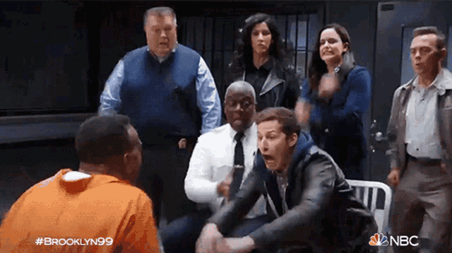 a group of people are standing around a man in a jail cell with the words brooklyn99 on the bottom