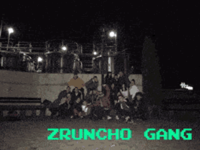 a group of people are posing for a picture and the words zruncho gang are visible in green