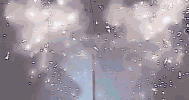 a close up of water bubbles in a glass of water .