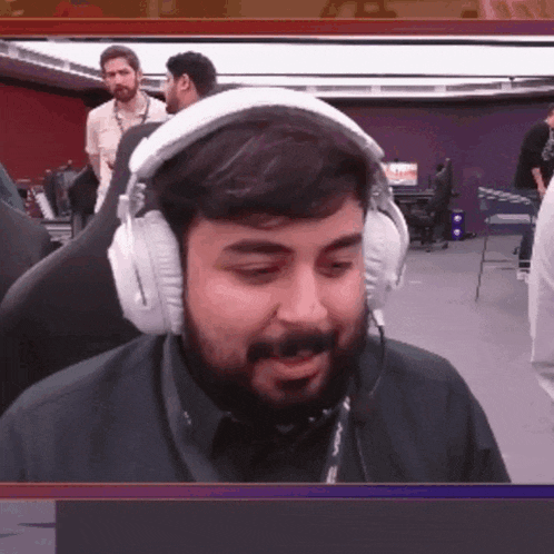 a man with a beard is wearing headphones and a microphone