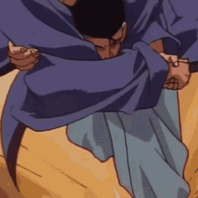 a man in a blue shirt and blue pants is being held by another man