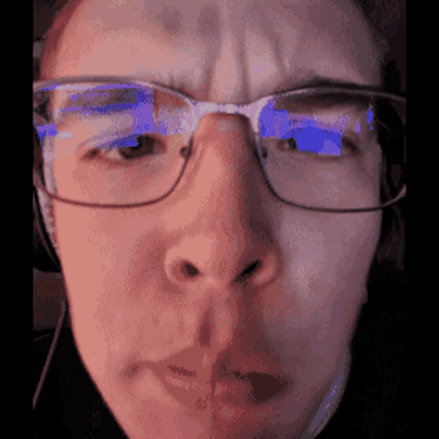 a close up of a person 's face wearing glasses