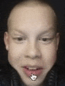 a close up of a boy 's face with a crown in his mouth and headphones .