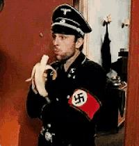 a man in a nazi uniform is holding a banana