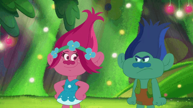 a couple of trolls standing next to each other in a forest