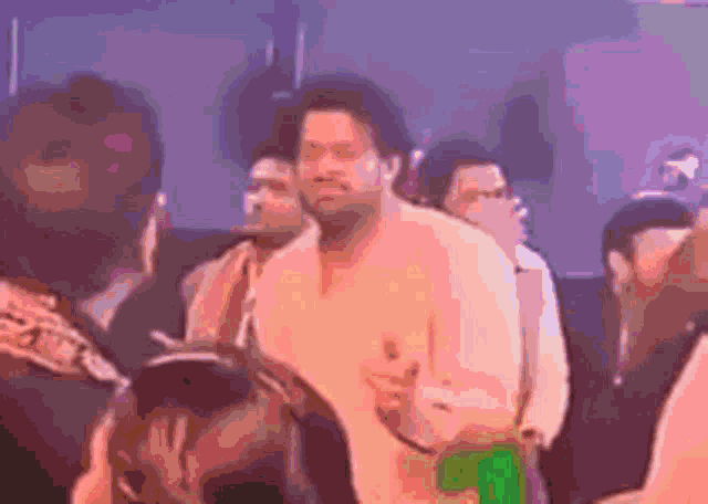 a man is standing in the middle of a crowd of people .