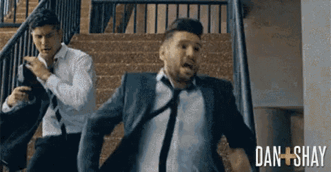 a man in a suit and tie is running down stairs .