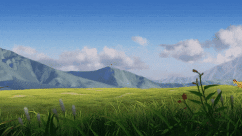 a grassy field with mountains in the background and a blue sky