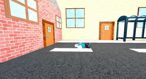 a cartoon character is laying on the ground in front of a brick wall