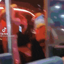 a tiktok video of a group of people standing around a window