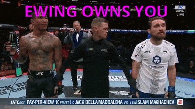a man in a ufc shirt stands in front of a referee