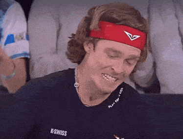 a man wearing a headband that says k-swiss