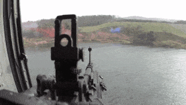 a machine gun is pointing at a body of water ..