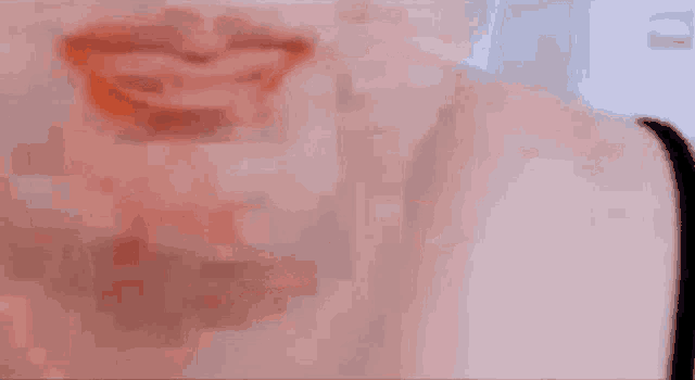 a close up of a woman 's face with a blurred background .