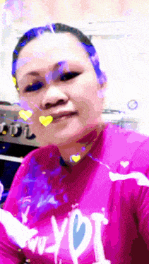 a woman is wearing a pink shirt that says " i love you "