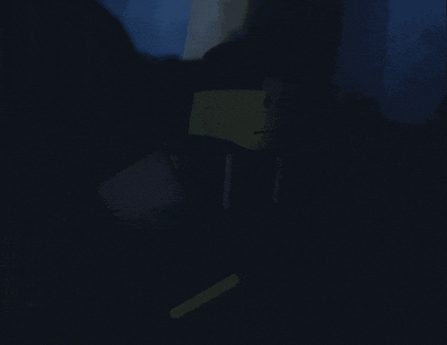 a person is standing in the dark wearing a mask