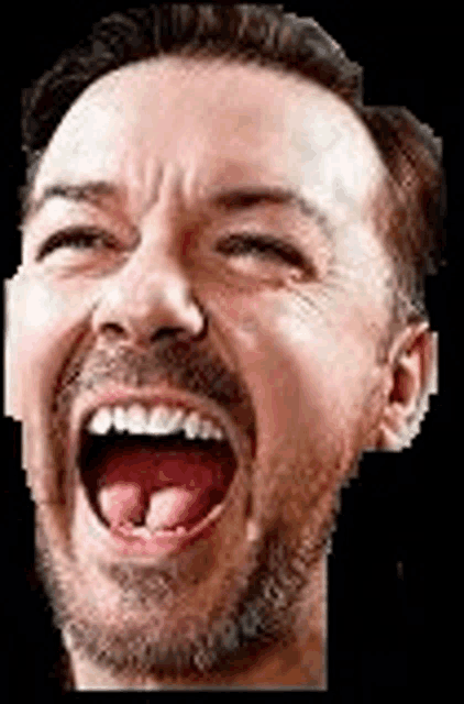 a man with a beard is laughing with his mouth open and his tongue out .
