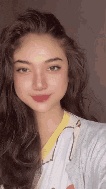 a woman taking a selfie with a white shirt on