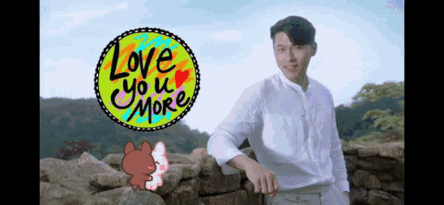 a man leaning against a stone wall with a sign that says love you more