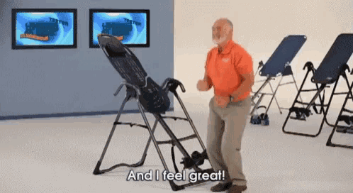 a man is standing in front of an inversion machine and says and i feel great .
