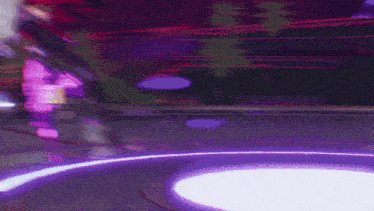 a blurry picture of a purple and red background with the letter t in the middle