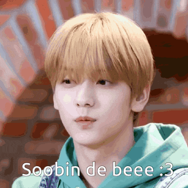 a young man with blonde hair is wearing a green hoodie and says soobin de bee