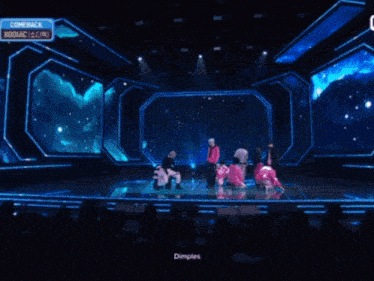 a group of people on a stage with a sign that says genie on it
