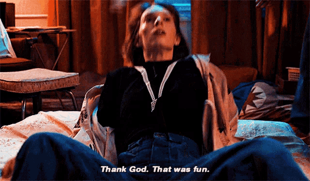 a woman is laying on a bed and saying " thank god that was fun "