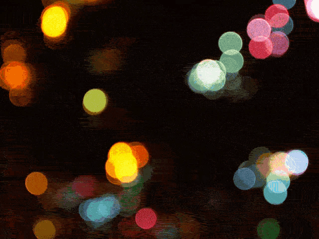 a blurry picture of a bunch of lights with a black background