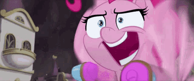 pinkie pie from my little pony is making a funny face while standing in front of a building .