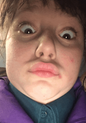 a close up of a person making a face