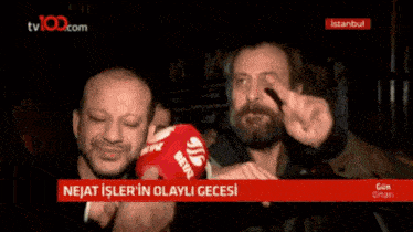 a man with a beard is being interviewed on a tv channel