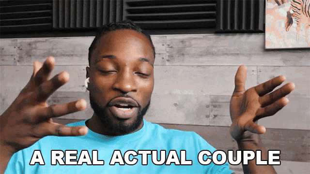 a man says a real actual couple with his hands outstretched