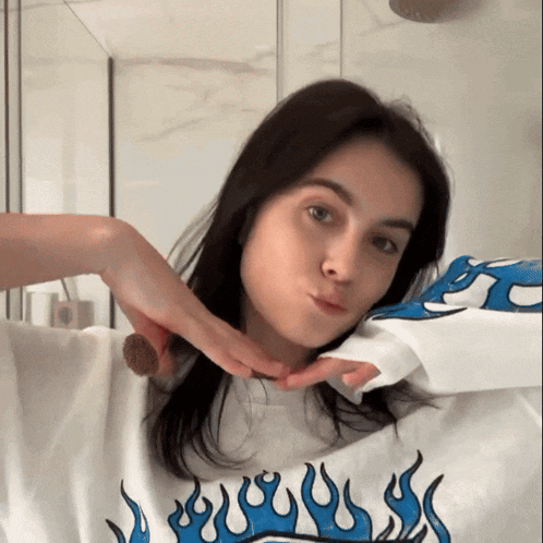 a woman wearing a shirt with blue flames on it
