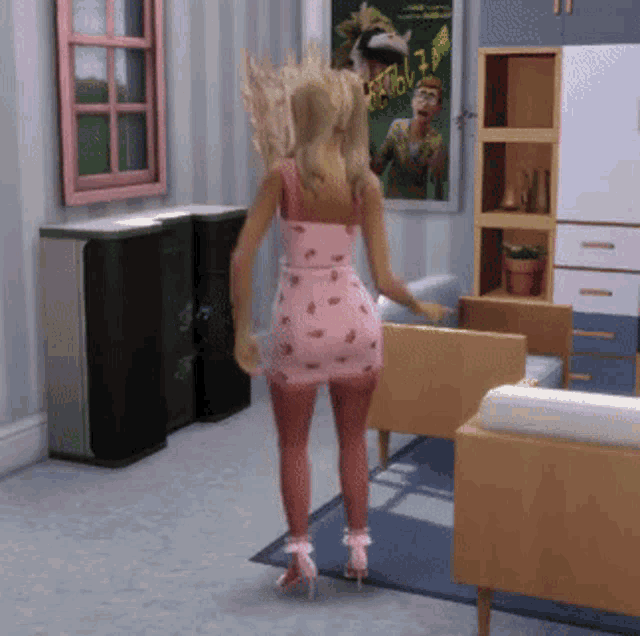 a woman in a pink dress is standing in a living room with a picture on the wall that says ' i love you '