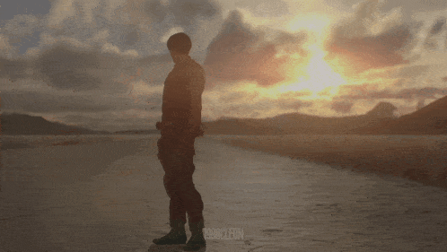 a silhouette of a man standing on a road with the year 1980 on the bottom left