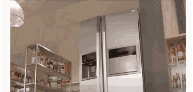 a lg refrigerator sits in a kitchen surrounded by shelves