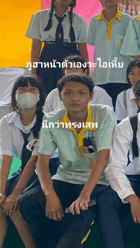 a group of people are posing for a picture and one of them is wearing a yellow shirt