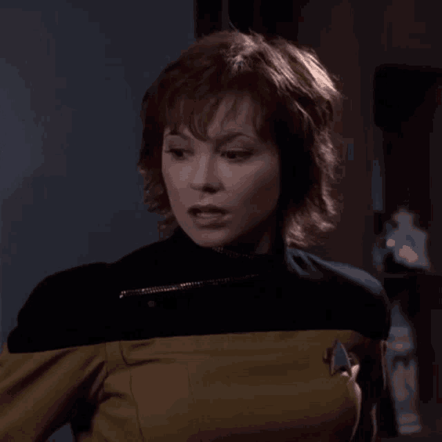 a woman in a star trek uniform has her mouth wide open