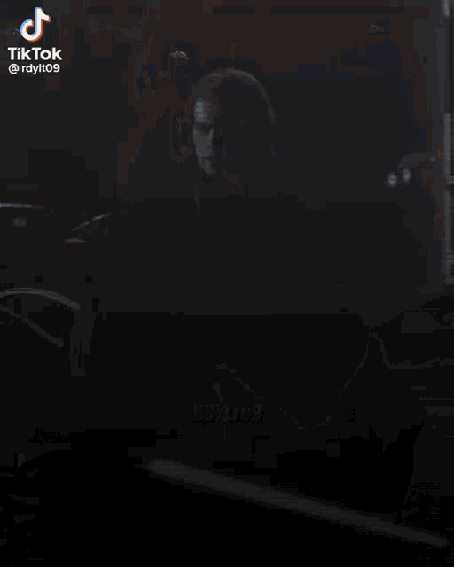 a blurry picture of a person standing in front of a locker with tiktok written on the bottom right corner