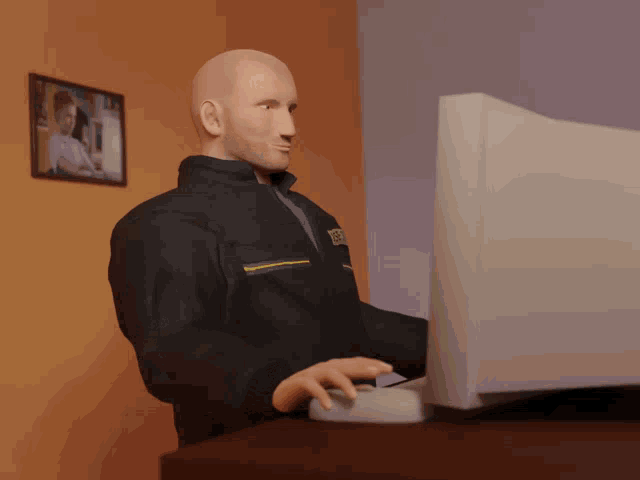 a man wearing a jacket that says ' dhl ' on it is typing on a keyboard