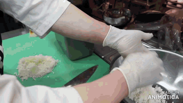 a person wearing white gloves is preparing food on a green cutting board made in animatica