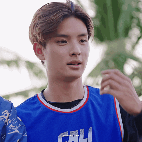 a close up of a person wearing a blue cali jersey