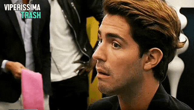 a close up of a man 's face with the words " viperissima trash " above him