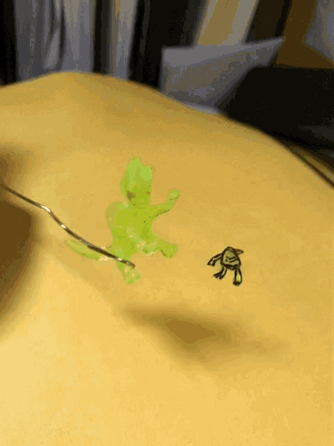 a drawing of a turtle and a green frog on a piece of paper