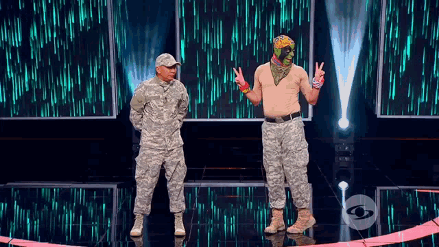 two men in military uniforms standing on a stage