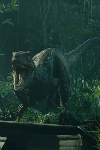 a dinosaur with its mouth open is walking through a dark forest