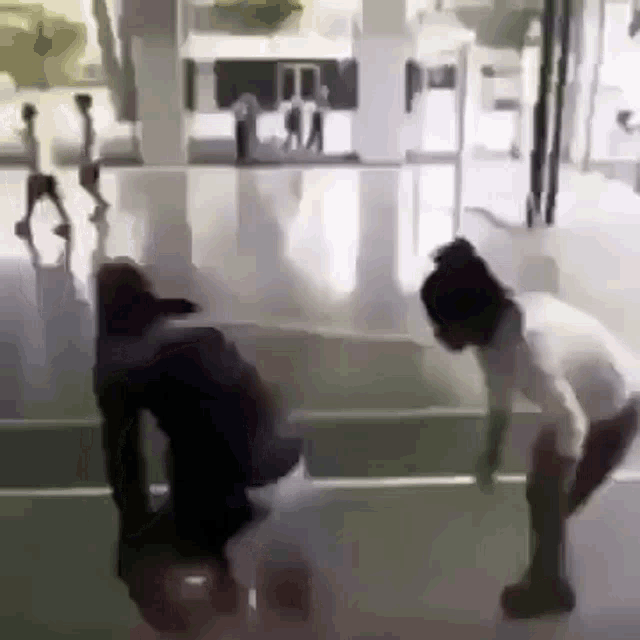 a man and a woman are playing basketball on a court .