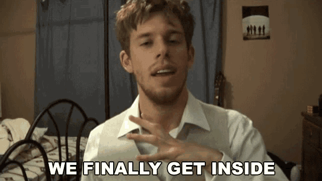 a man says " we finally get inside " while standing in front of a bed
