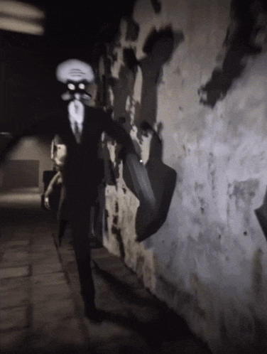 a man with a squid head is walking down a dark alleyway